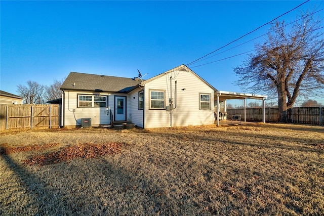 view of front of property with a fenced backyard and central AC unit