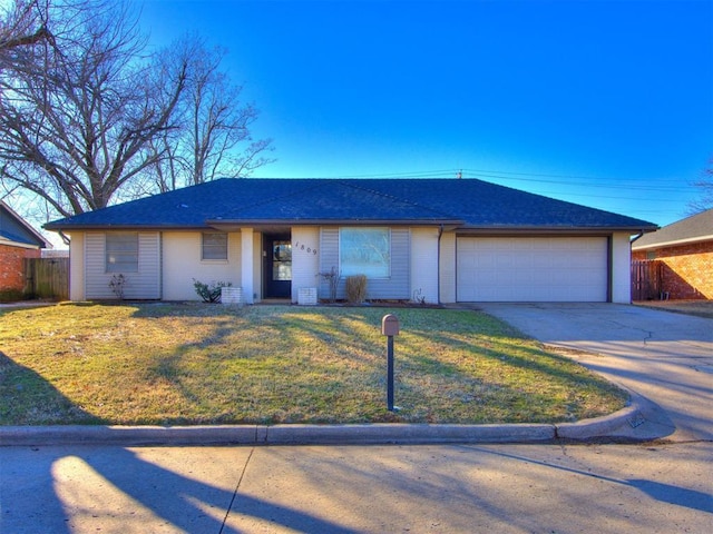 single story home with driveway, an attached garage, fence, and a front yard