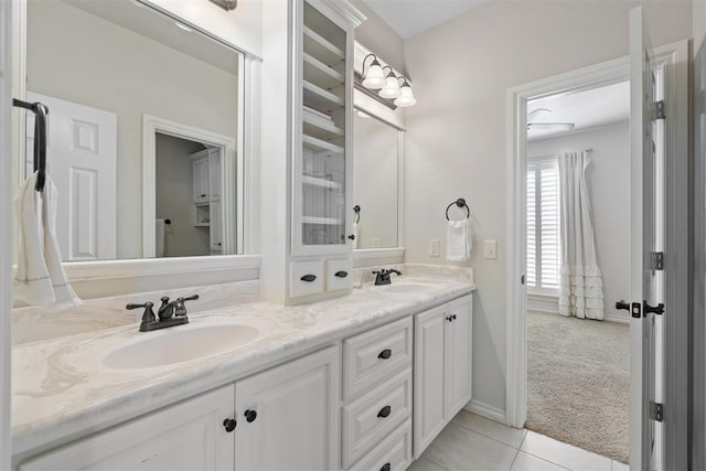 full bathroom with tile patterned floors, a sink, and double vanity