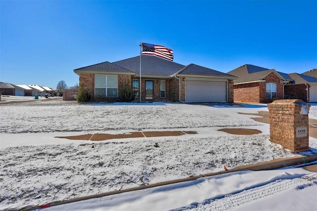 single story home with brick siding and an attached garage