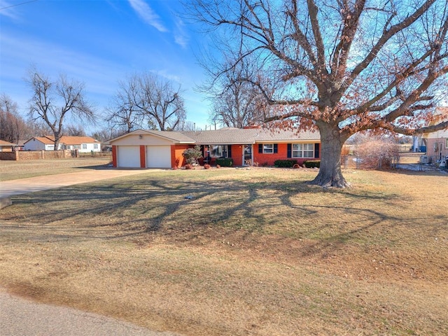 single story home featuring a garage, concrete driveway, and a front lawn