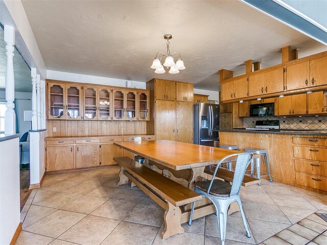 dining room featuring light tile patterned flooring and an inviting chandelier