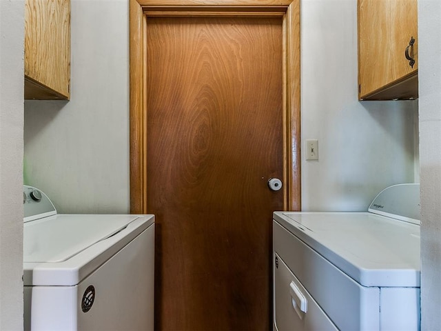 washroom with cabinet space and independent washer and dryer