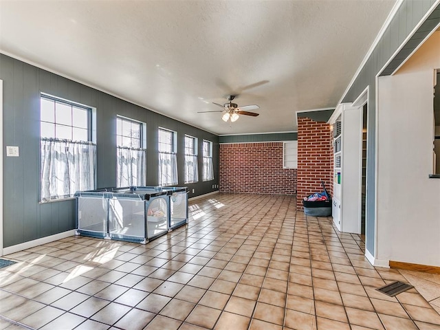 unfurnished sunroom with a ceiling fan