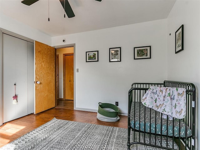 bedroom featuring a ceiling fan, baseboards, and wood finished floors