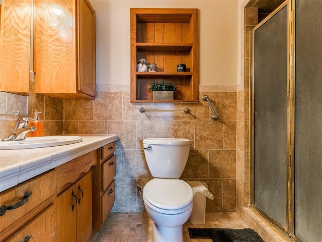 full bathroom featuring a stall shower, tile walls, vanity, and toilet