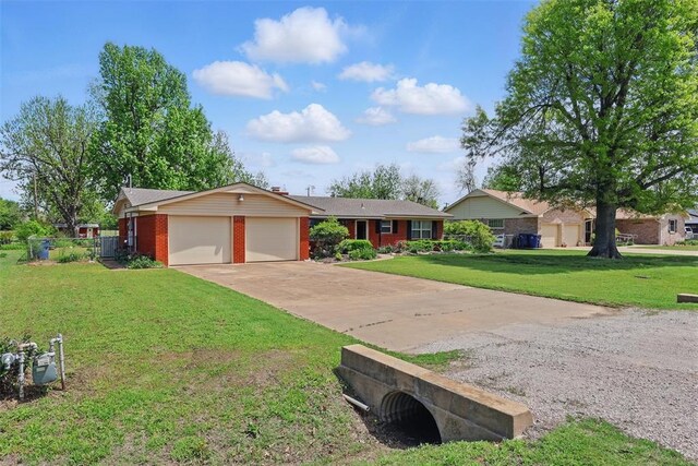 406 S Pine St, Crescent, OK 73028 - ranch-style house with driveway, fence, a front lawn, brick siding, and a garage