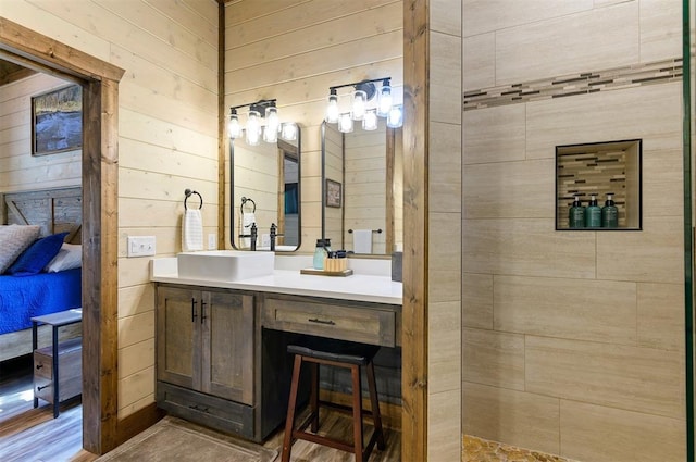 full bath with wooden walls and vanity