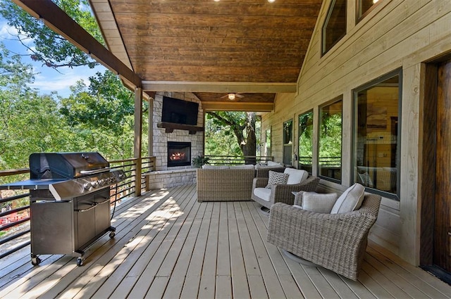 wooden deck with an outdoor living space with a fireplace