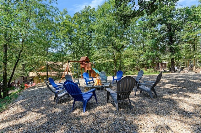 view of yard with a fire pit and a playground