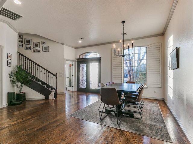 dining room with visible vents, dark wood finished floors, ornamental molding, stairs, and a notable chandelier