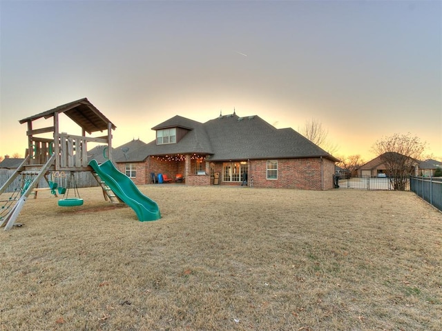 view of jungle gym with a fenced backyard and a yard