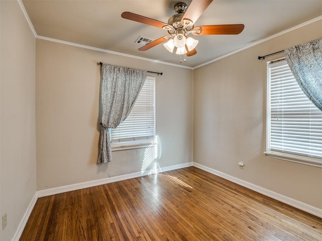 spare room featuring crown molding, visible vents, light wood-style floors, a ceiling fan, and baseboards