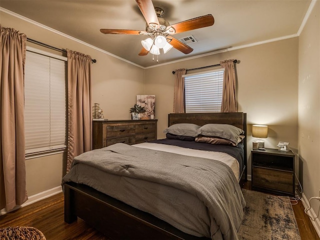 bedroom with ornamental molding, dark wood-style flooring, visible vents, and baseboards