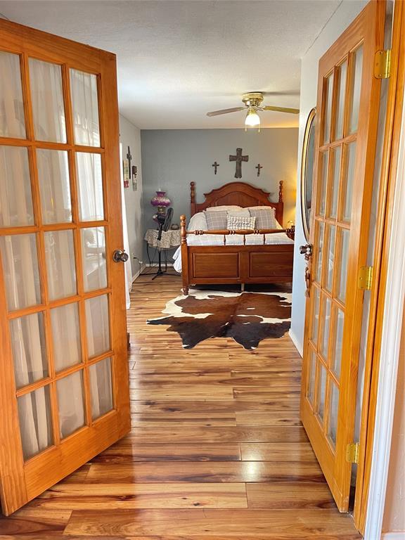 bedroom featuring french doors and light wood finished floors