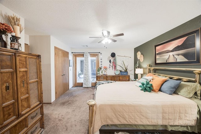 bedroom with carpet, access to outside, ceiling fan, and a textured ceiling