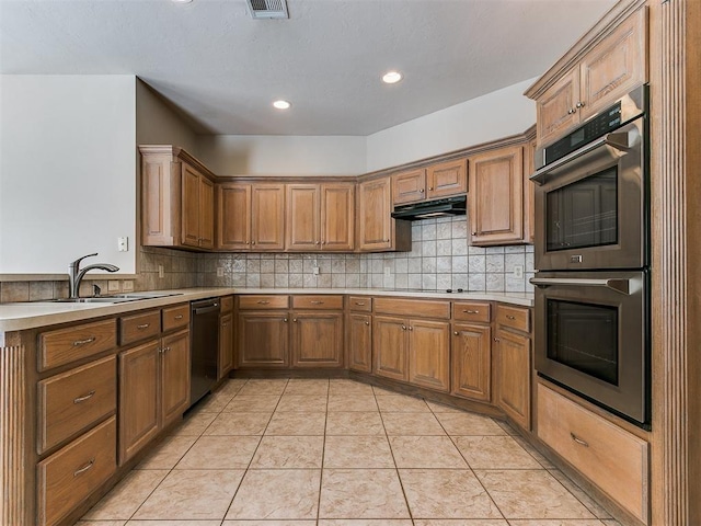 kitchen with brown cabinets, stainless steel double oven, light countertops, and dishwasher