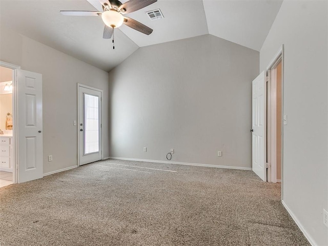 unfurnished bedroom featuring ensuite bathroom, carpet floors, visible vents, baseboards, and vaulted ceiling