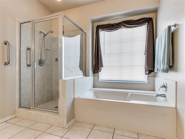 full bathroom featuring baseboards, a shower stall, a bath, and tile patterned floors