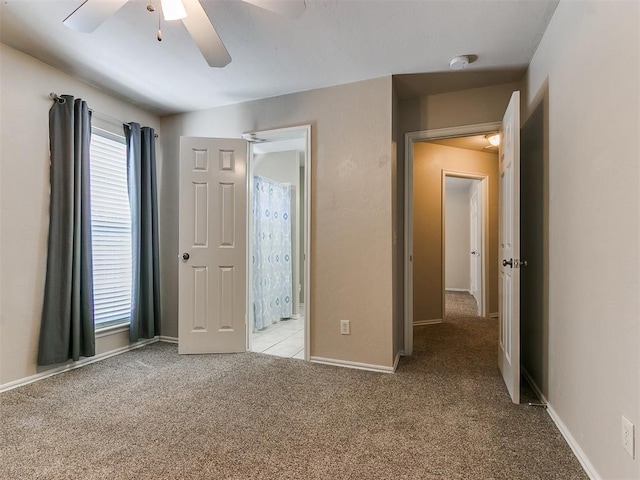 unfurnished bedroom featuring light carpet, a ceiling fan, and baseboards