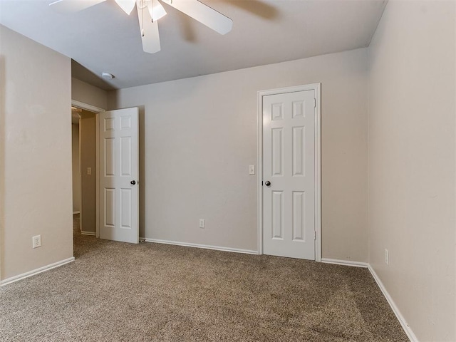 unfurnished bedroom featuring carpet floors, ceiling fan, and baseboards