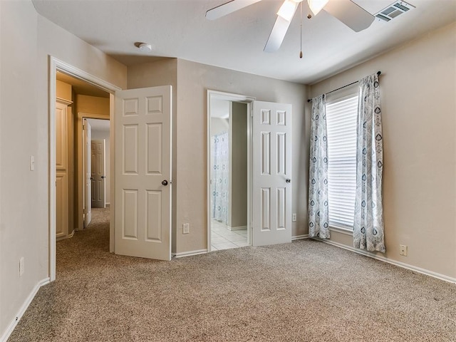 unfurnished bedroom with light carpet, baseboards, visible vents, and a ceiling fan