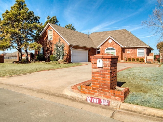 view of front of home featuring a front yard, concrete driveway, and brick siding