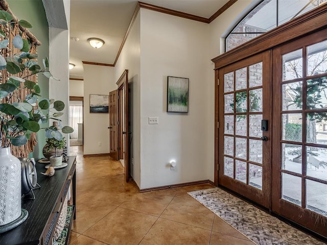 doorway to outside with ornamental molding, french doors, light tile patterned floors, and baseboards