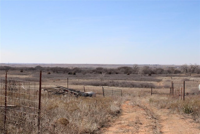 view of yard featuring fence and a rural view