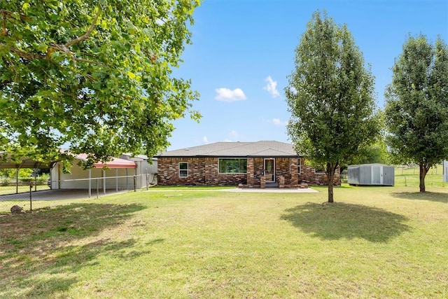 view of yard featuring a carport and fence