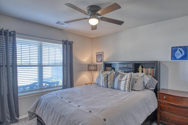 bedroom with ceiling fan, carpet, visible vents, and baseboards