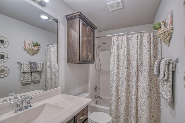 bathroom featuring toilet, shower / bath combo with shower curtain, vanity, and visible vents