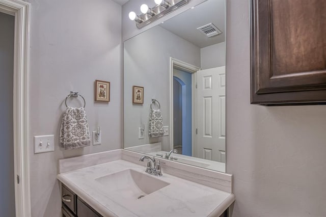 bathroom featuring vanity and visible vents