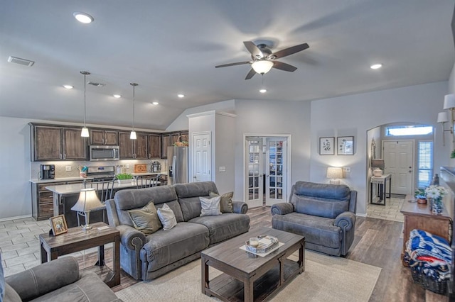 living area with recessed lighting, visible vents, and vaulted ceiling