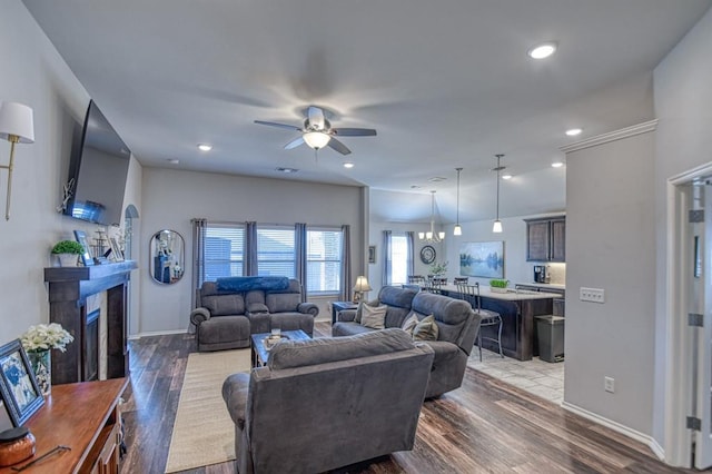 living room with ceiling fan, recessed lighting, a fireplace, and wood finished floors