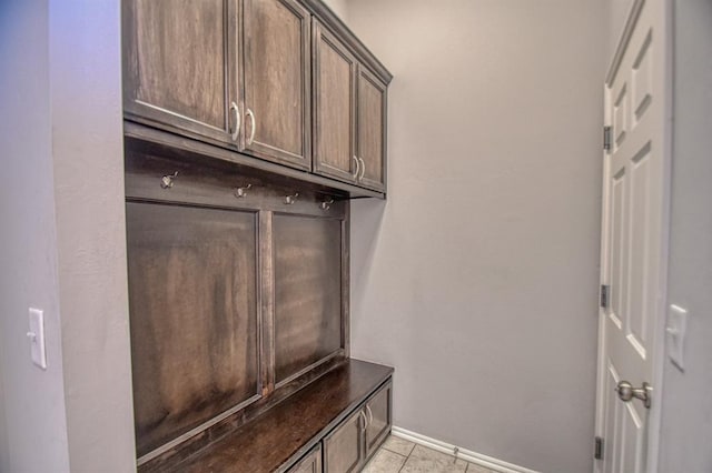 mudroom featuring light tile patterned flooring and baseboards