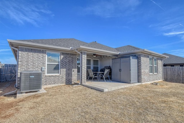 back of property featuring a patio area, fence, cooling unit, and brick siding