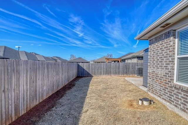 view of yard featuring central air condition unit, a patio area, and a fenced backyard