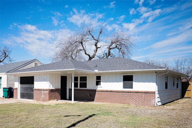 view of front of home featuring a garage, brick siding, board and batten siding, and a front lawn