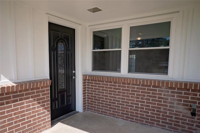 entrance to property with brick siding