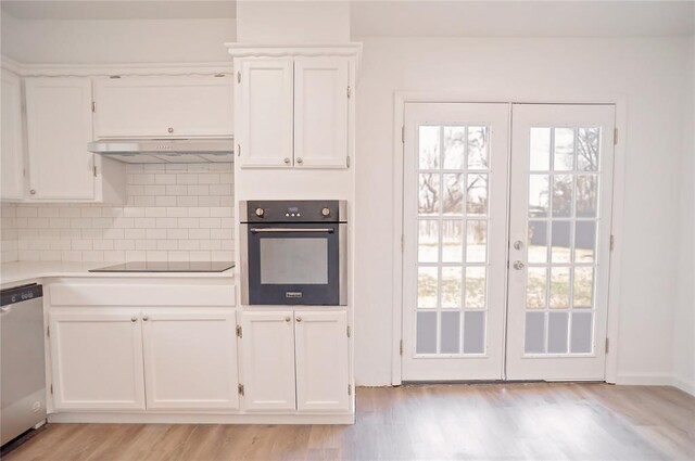 kitchen with dishwasher, oven, black electric stovetop, under cabinet range hood, and white cabinetry