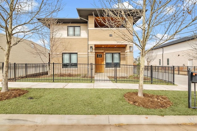 view of front of home featuring brick siding, a fenced front yard, and a front lawn