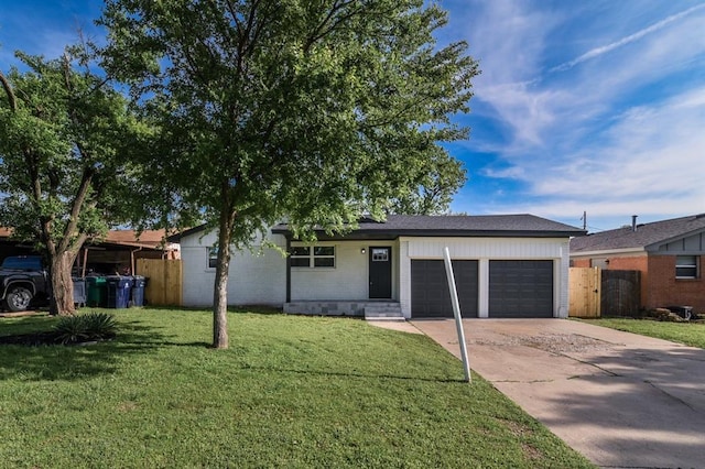 ranch-style house featuring a garage, concrete driveway, a front yard, and fence