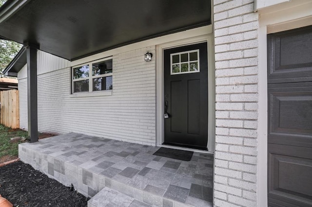 entrance to property with brick siding