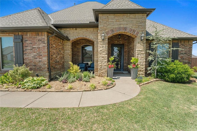 1525 NW 176th St, Edmond, OK 73012 - doorway to property featuring roof with shingles, brick siding, and a lawn