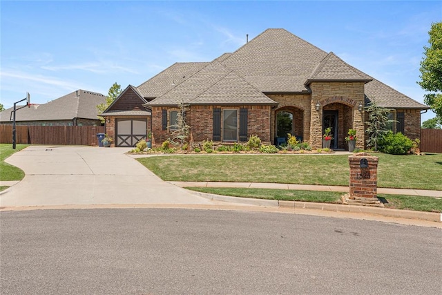 1525 NW 176th St, Edmond, OK 73012 - french country home with driveway, brick siding, roof with shingles, an attached garage, and stone siding