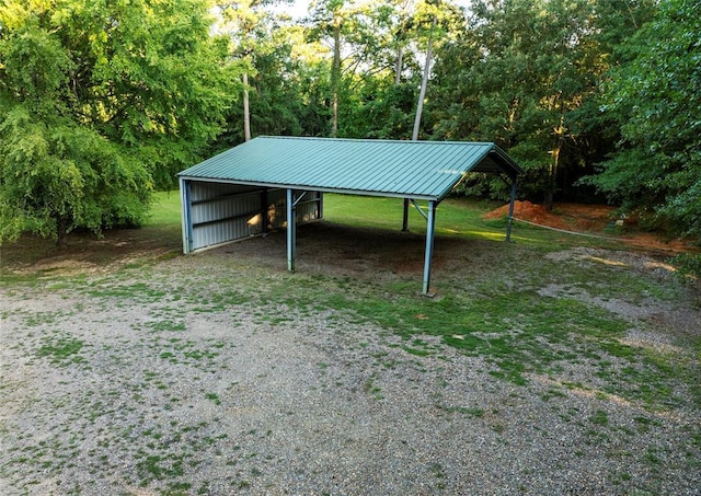 exterior space featuring an outbuilding, driveway, an outdoor structure, and a detached carport