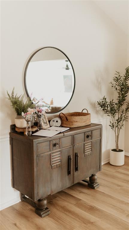 interior space with a wainscoted wall and wood finished floors