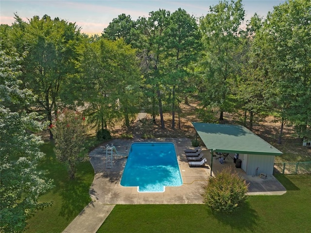 view of pool with a lawn, a patio area, fence, and a fenced in pool