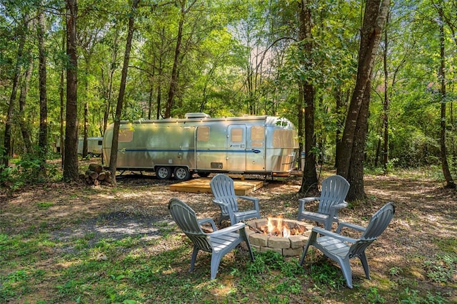 view of yard with a fire pit